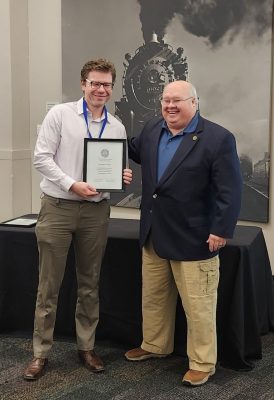 A researcher is presented with an award